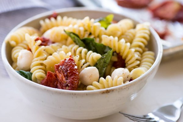 3-ingredient pasta salad: fusilli + oven-dried tomatoes + mozzarella + basil