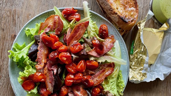 A BLT salad with a stack of buttered toast