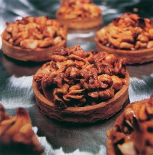 A bunch of nuts in a tart