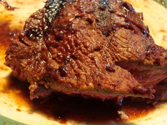 A cup of coffee BBQ sauced steak