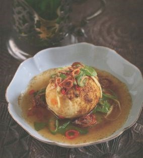 A deep-fried egg with lime chilli dressing, garam masala and crispy shallots