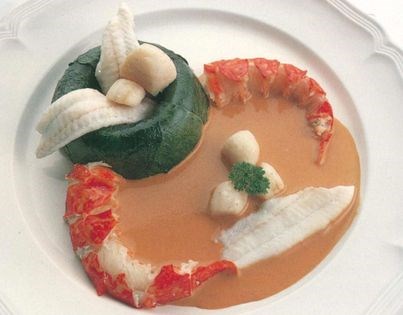 A little savarin of fish mousse with seafood and lobster coulis