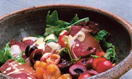 A salad of summer leaves, cured pork and cherries