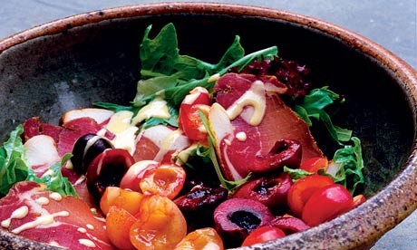 A salad of summer leaves, cured pork and cherries