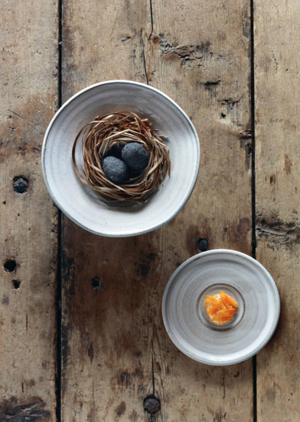 A small egg coated in (sheep's shit) ash, sauce made from dried trout and pickled marigold