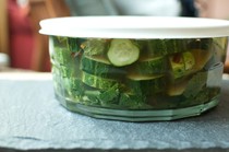 A very large bowl of pickles for a potluck