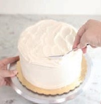 Adding texture to frosting using a spoon or small offset spatula to create swirls 