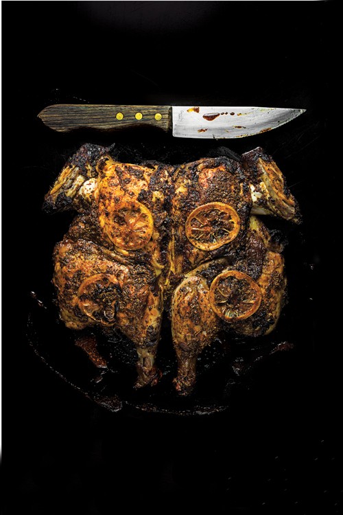 Adobo chicken under a brick
