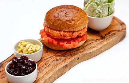 Alaska salmon burger with beetroot chutney, dill pickles and salad with sour cream dressing