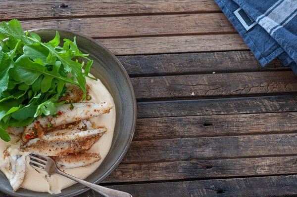Almond crusted fish with hummus & green chilli oil