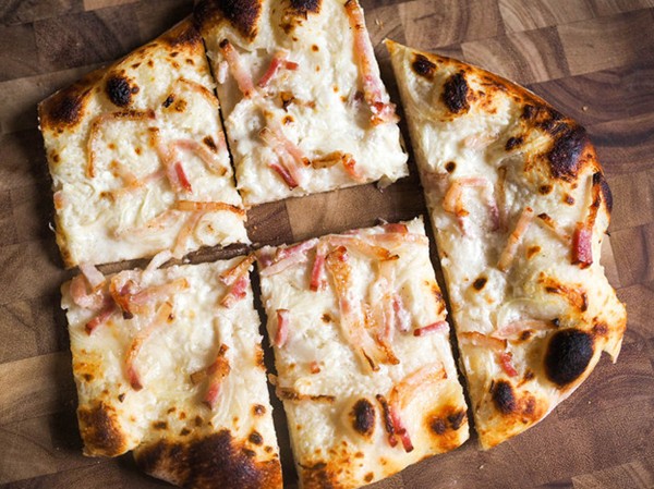 Alsatian pizza with fresh cheese, onions, and bacon (Classic tarte flambée)