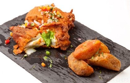 Amritsar-spiced Alaska halibut with mustard mushy peas, caper kachumber and tandoori potato wedges