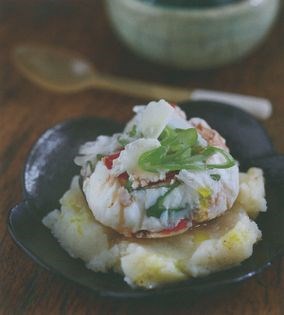 An egg poached in black vinegar, truffle oil, chilli and spring onions on Parmesan mashed potato