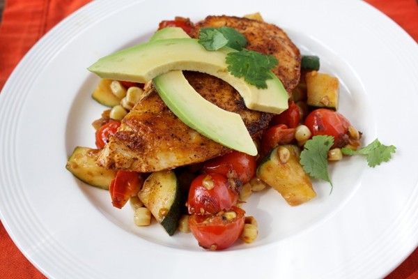 Ancho chicken with warm corn, zucchini and tomato salad