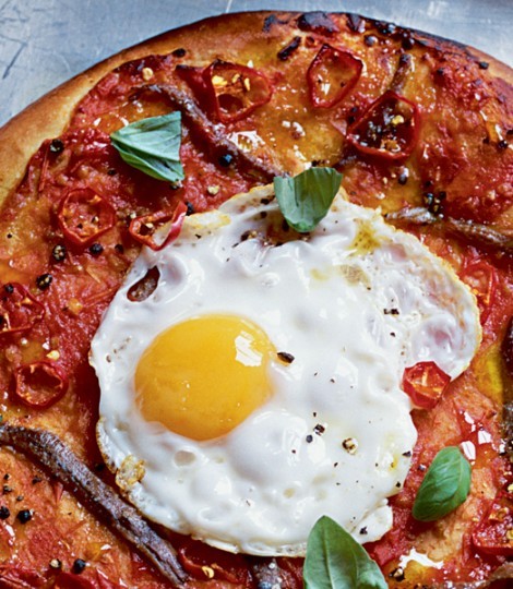 Anchovy and fried egg pizzas