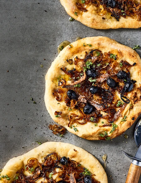 Anchovy pizza with caramelised onions and thyme honey