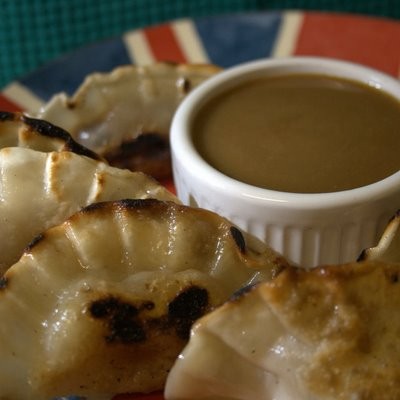 Apple & blueberry gyoza with a hot peanut butter sauce