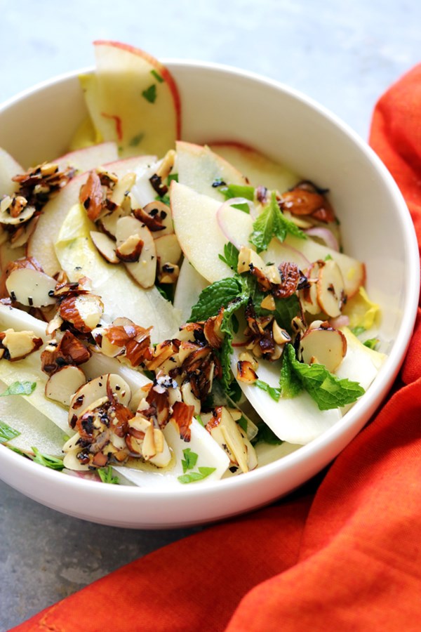 Apple and endive salad with parsley, mint, and salted almonds