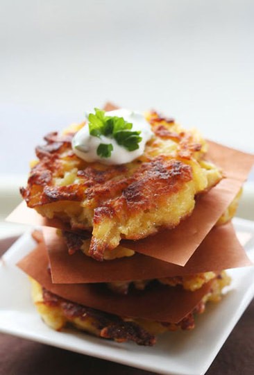Apple and potato fritters with sour cream and herb dipping sauce