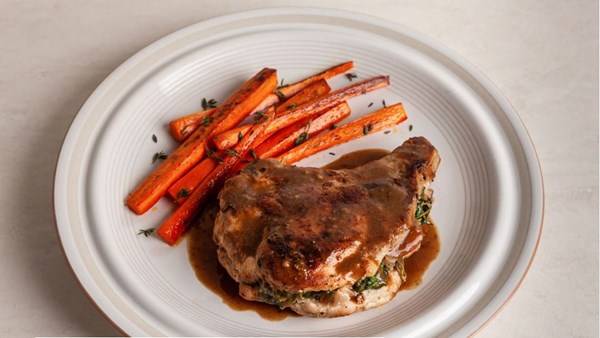 Apple and spinach-stuffed pork chops with mustard wine sauce