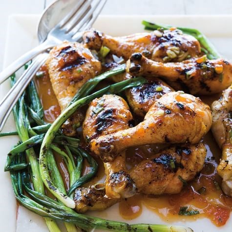Apricot-sriracha drumsticks with grilled green onions