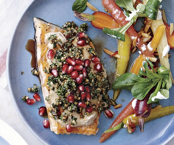 Arctic char with tahini sauce, nuts, and herbs