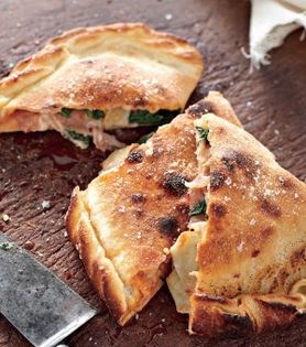 Artichoke, prosciutto, spinach, and mozzarella calzone