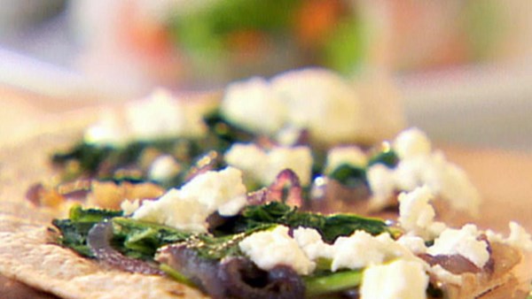 Arugula, caramelized onion, and goat cheese pizza