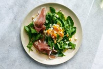 Arugula salad with chopped egg and prosciutto