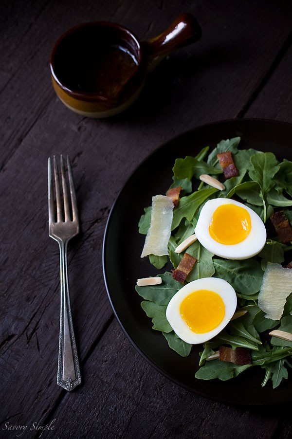 Arugula salad with soft boiled eggs, bacon, and shallot Dijon vinaigrette