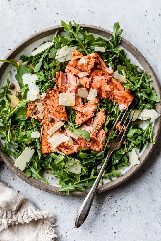 Arugula salmon salad with capers and shaved Parmesan