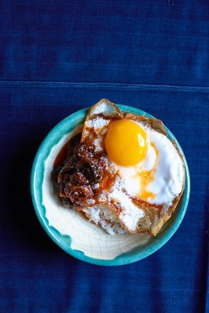 Asian sofrito with fried egg over rice