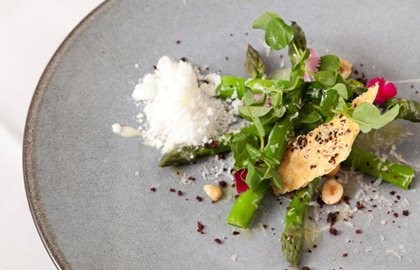 Asparagus with Parmesan snow, olive biscuit and hazelnuts
