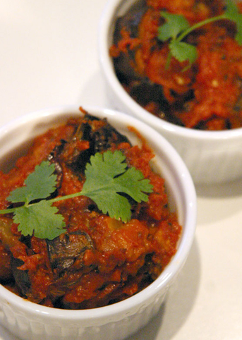 Aubergine baked with tangy pickling spices (Achari baingan)