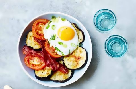 Aubergine stack with egg, bacon and tomato