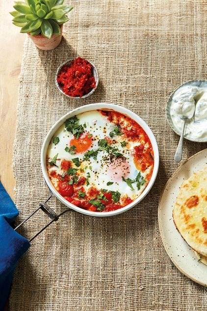 Aubergine, tomato and harissa baked eggs with tahini and honey flatbreads