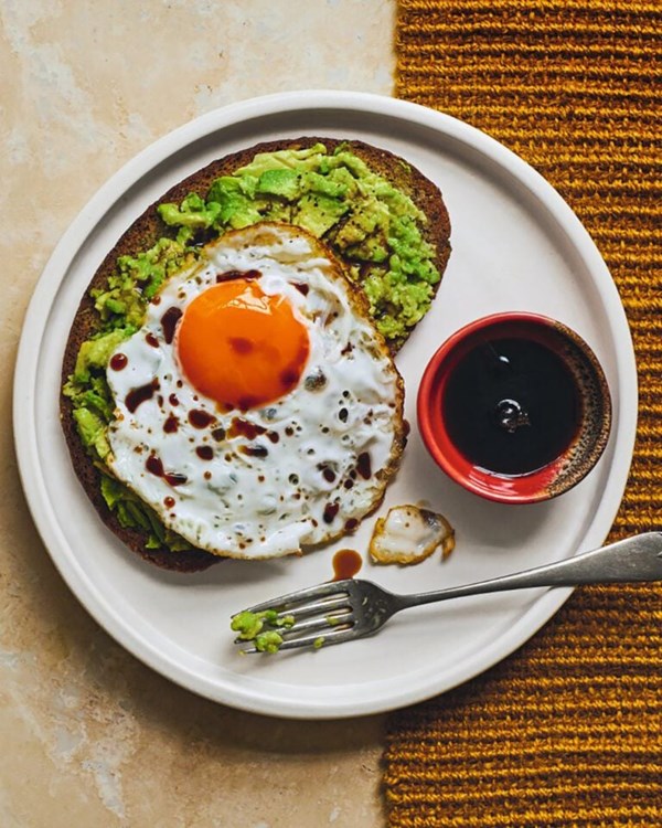 Avo on rye with sunny crispy eggs and a drizzle of soy