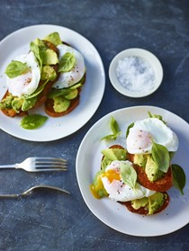 Avocado and poached egg on rye with basil and sea salt