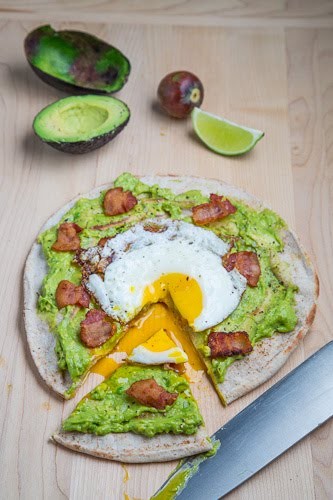 Avocado breakfast pizza with fried egg