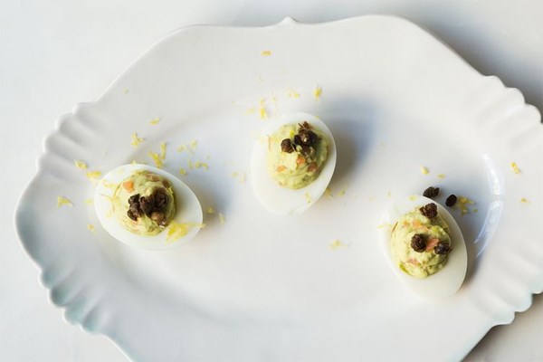Avocado deviled eggs with smoked salmon and fried capers