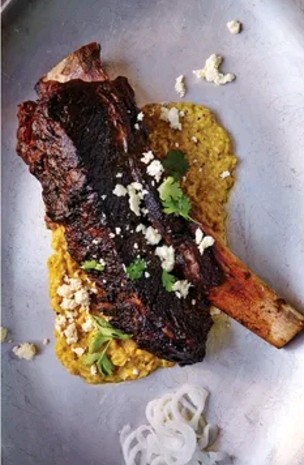 Avocado-leaf short ribs with serrano-chile creamed corn