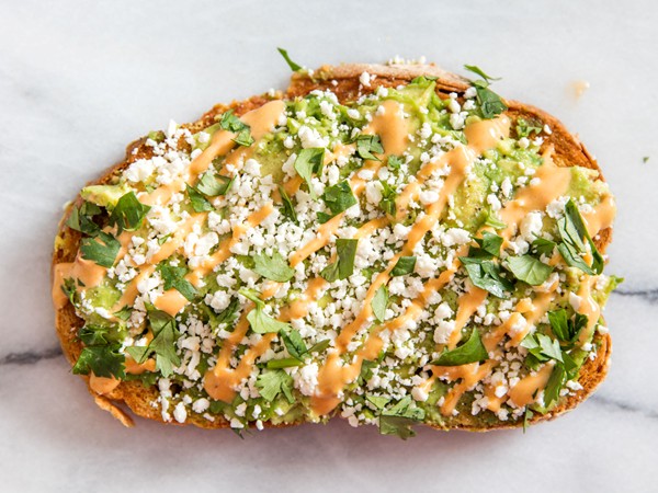 Avocado toast with chipotle mayo, cotija cheese, cilantro, and lime