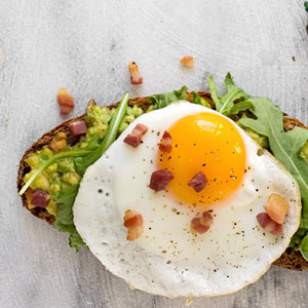 Avocado toast with egg, arugula & bacon