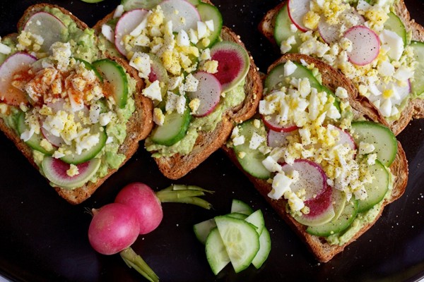 Avocado toast with egg, cucumber and radish