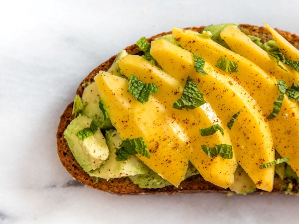 Avocado toast with mango, chili powder, and mint