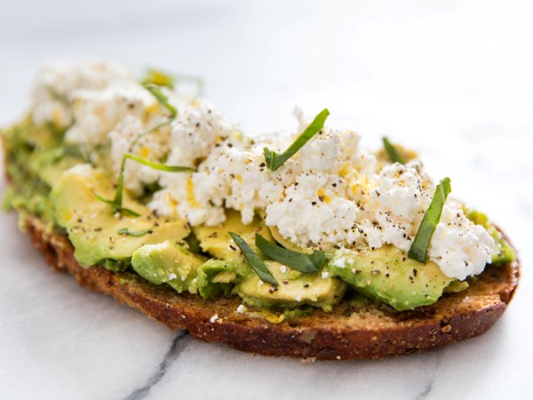 Avocado toast with ricotta, olive oil, lemon zest and basil