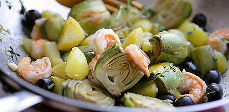 Baby artichokes with potatoes, garlic, olives, and shrimp