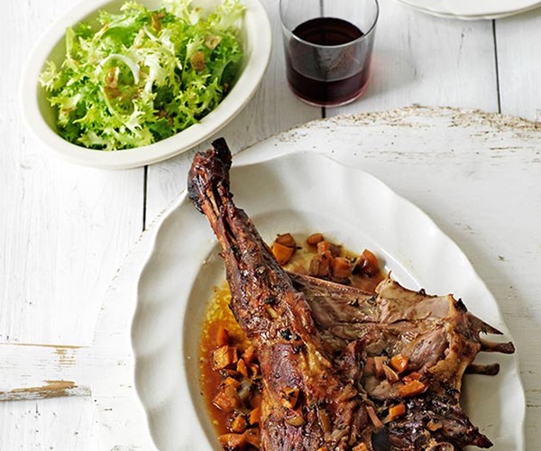 Baby goat roasted on a bed of aromatic vegetables (Cabrito asado)