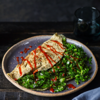Baby greens omelettes with garlic and chilli sauce