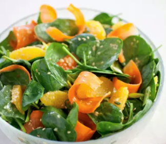 Baby spinach salad with carrot, orange, and sesame